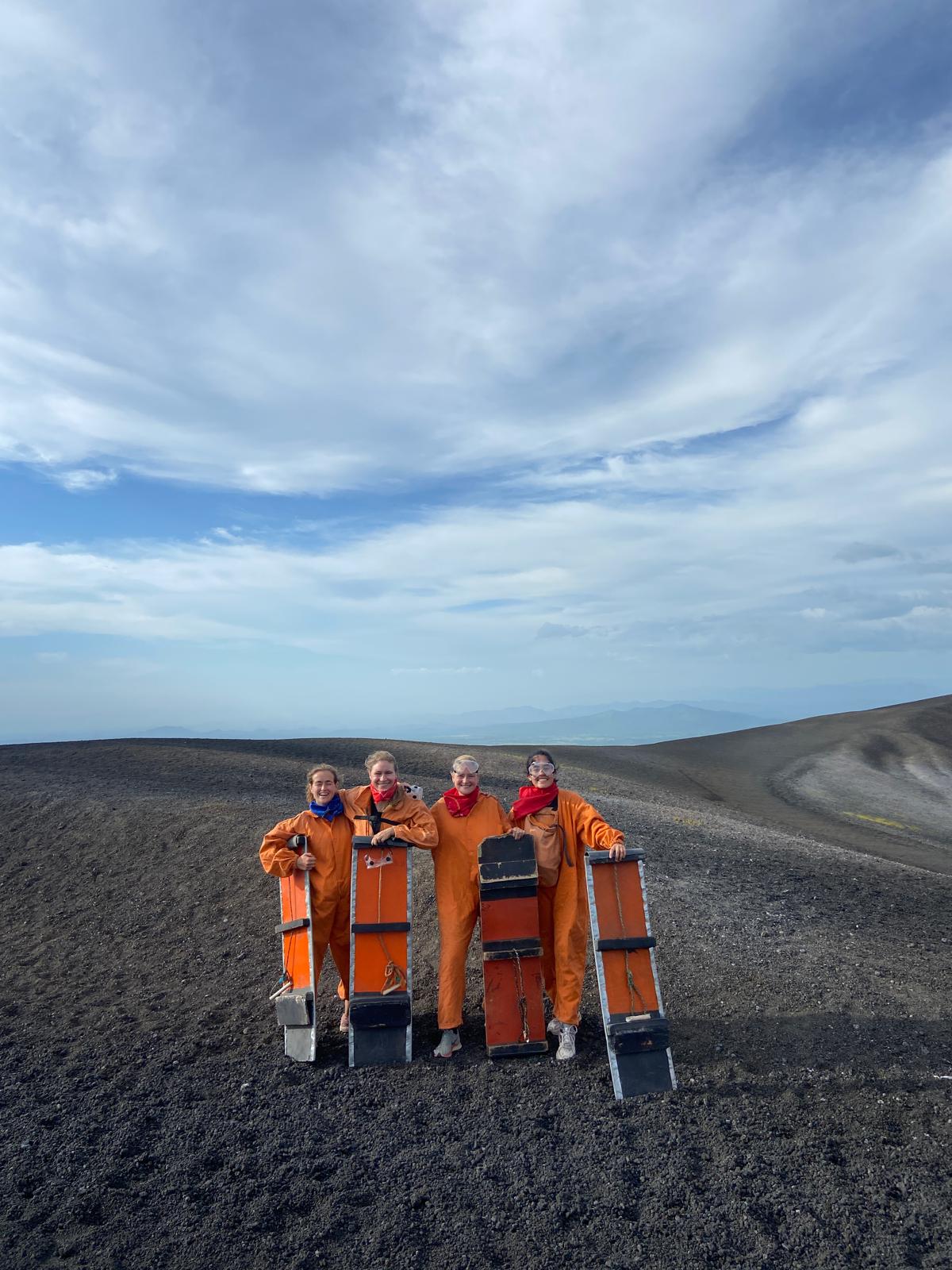 In overalls with boards at the top of Cerro Negro